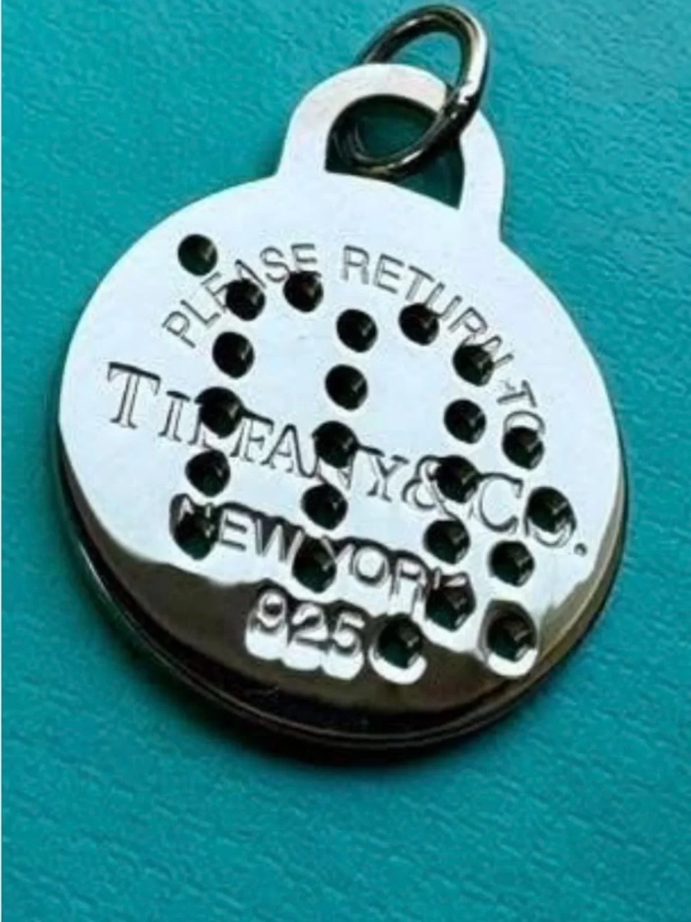 Tiffany & Co. Silver Virgo Round Pendant on Aqua Background